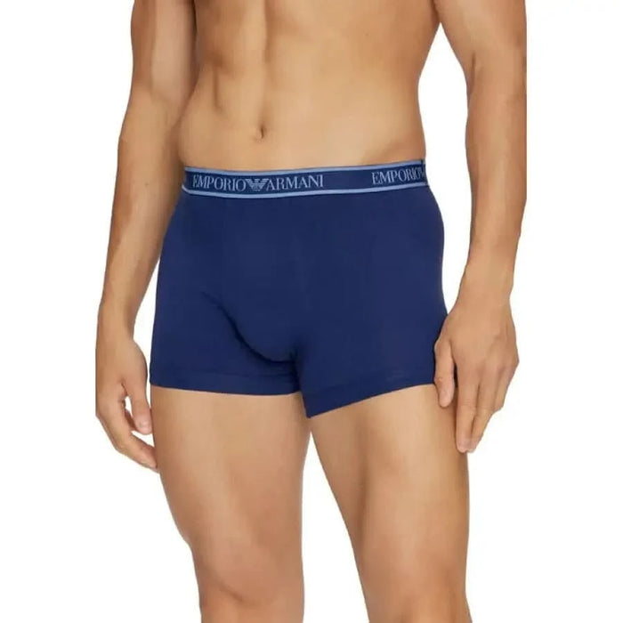 Navy blue Emporio Armani boxer briefs on a male torso for stylish comfort