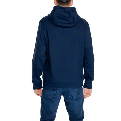 Navy blue hooded sweatshirt worn by person viewed from behind Tommy Hilfiger Men Sweatshirts