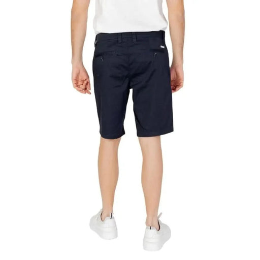 Armani Exchange men’s navy blue knee-length shorts worn by a person