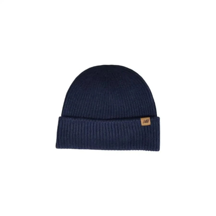 Navy blue knit beanie featuring a brown leather tag from New Balance Men Cap