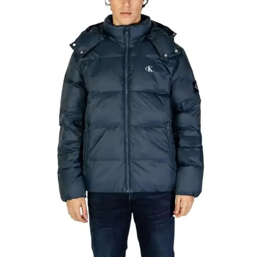 Navy blue puffy winter jacket with hood and zipper closure by Calvin Klein