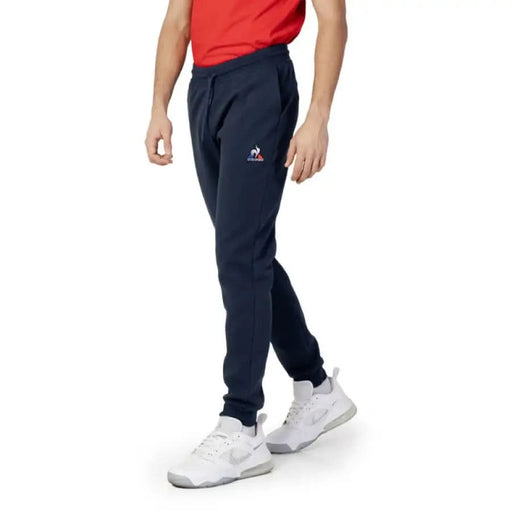 Navy blue sweatpants by Le Coq Sportif, featuring a small logo on the thigh