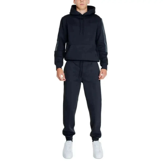 Calvin Klein Jeans navy blue sweatsuit with hooded sweatshirt, sweatpants, and white sneakers