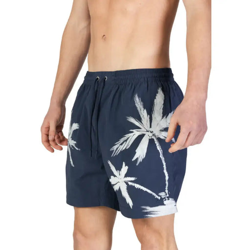 Navy blue swim shorts with white palm tree prints from Boss Men’s Blue Printed Swimwear