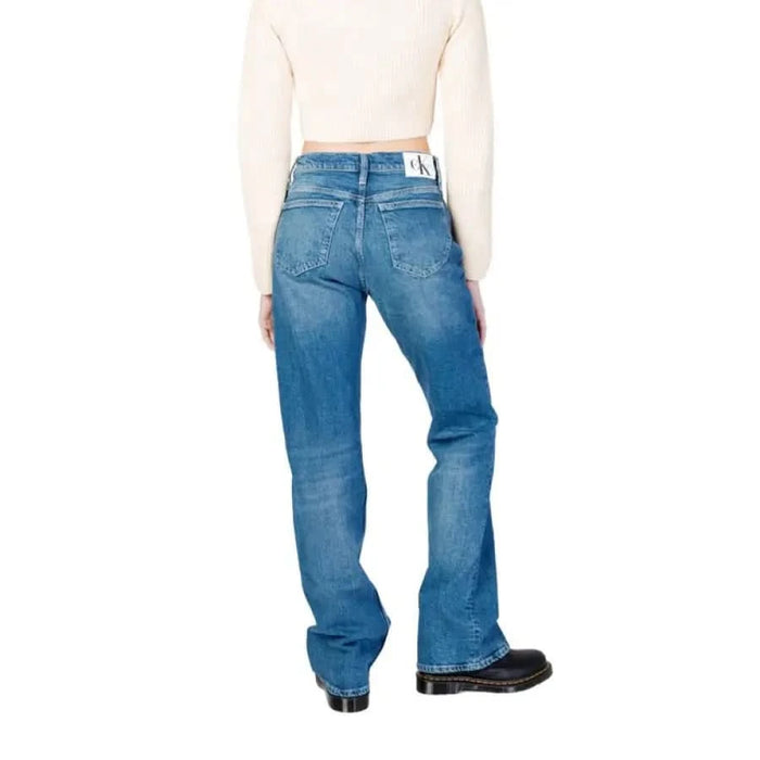 Calvin Klein Jeans - Women’s blue denim jeans paired with a white crop top. Elegant and stylish