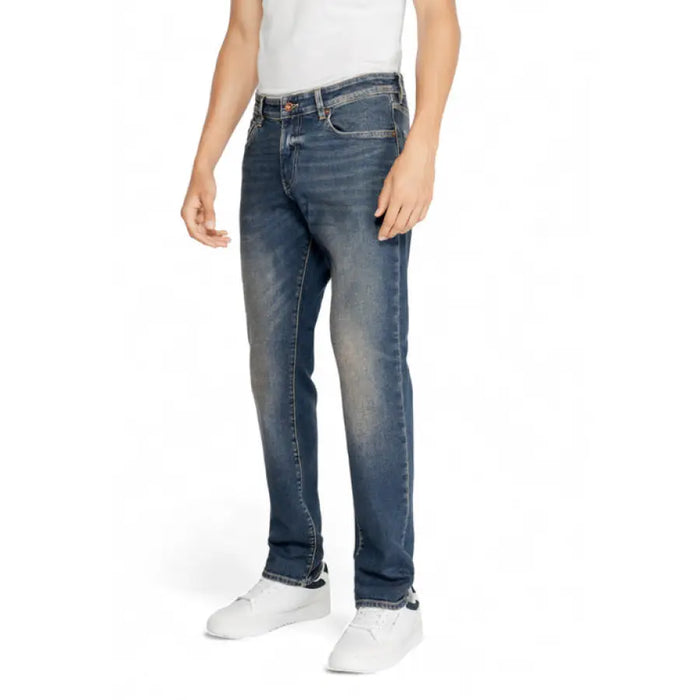 Blue denim jeans worn with a white shirt and sneakers from Gas Men Jeans collection