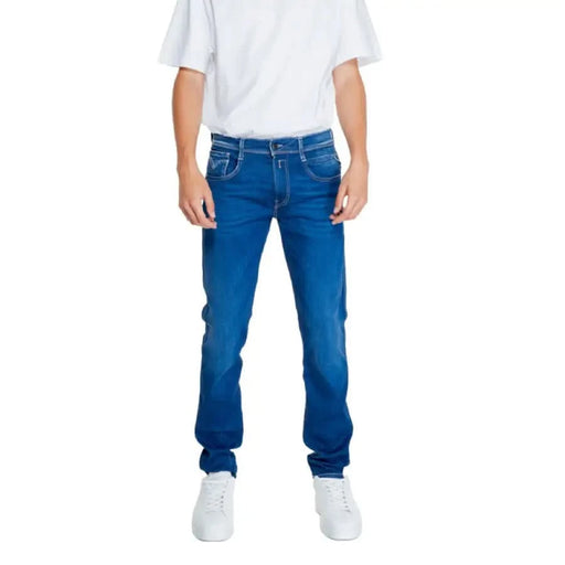 Pair of blue Replay jeans styled with a white t-shirt and sneakers for men