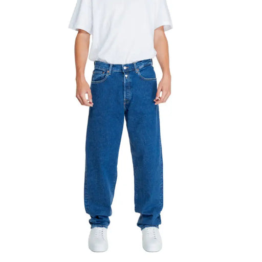 Loose-fitting blue Replay Men Jeans with a white t-shirt above the waistband