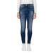 Blue skinny jeans worn with a white top and sneakers from Calvin Klein Jeans