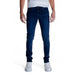 Dark blue skinny jeans paired with white sneakers by Antony Morato for men