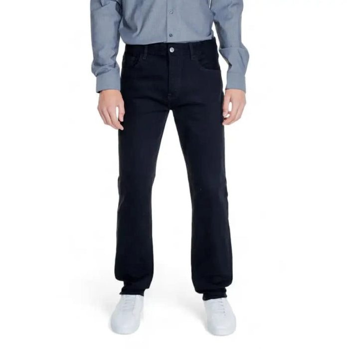 Armani Exchange Men Trousers: Dark blue jeans, light blue shirt, and white sneakers ensemble