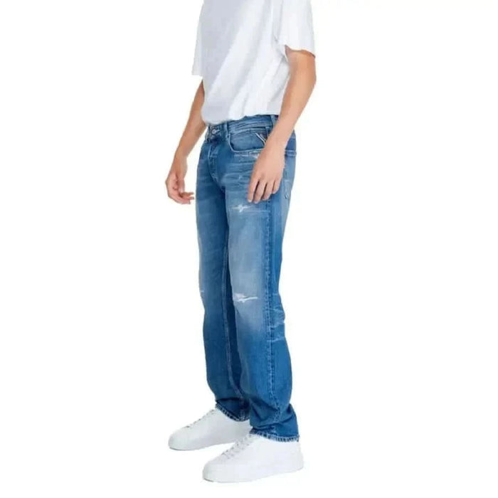 Pair of distressed blue Replay Men Jeans worn with a white t-shirt and sneakers