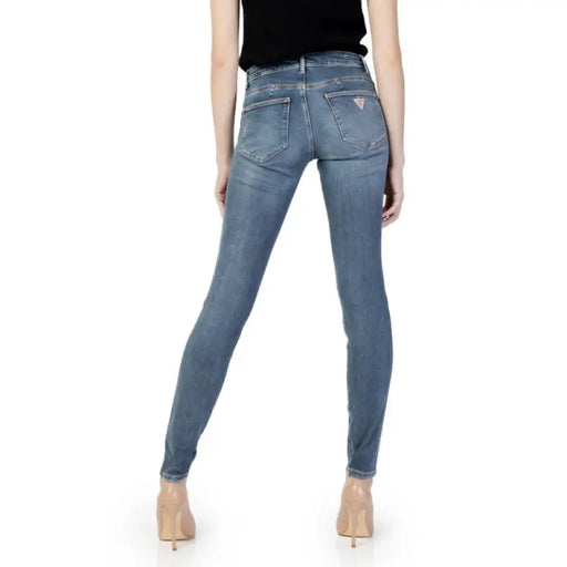 Light blue skinny jeans worn by a person from the waist down, Guess Women Jeans