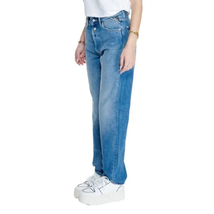 Pair of light blue Replay wide-leg jeans with white platform sneakers for women