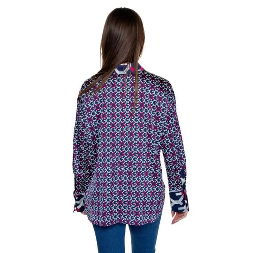 Guess patterned long-sleeved women’s shirt on person with long dark hair, back view