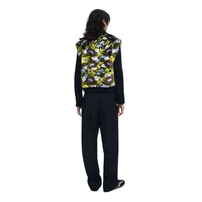 Person in a black outfit with floral vest, showcasing Desigual Women Jacket from behind