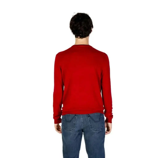 Person in bright red sweater and blue jeans showcasing U.S. Polo Assn. Men Knitwear