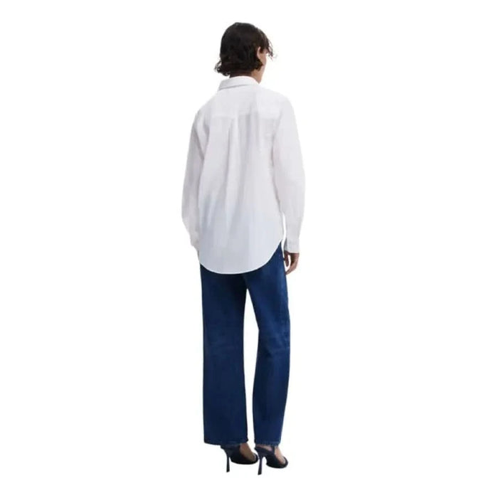 Person in a white shirt and navy pants showcasing Desigual Women’s Floral Cotton Shirt