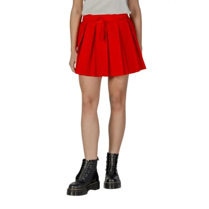 Red pleated mini skirt paired with black boots from the Spring Summer Collection