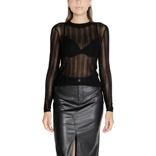 Sheer black long-sleeved top over black bra paired with leather pencil skirt from Vila Clothes