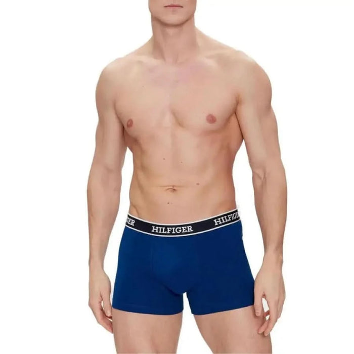 Shirtless male torso wearing blue Hilfiger boxer briefs Tommy Hilfiger Men Underwear