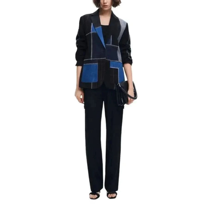 Stylish black and blue geometric patterned blazer over dark outfit by Desigual