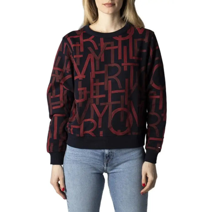 Sweater featuring red letter pattern on black background by Tommy Hilfiger Jeans