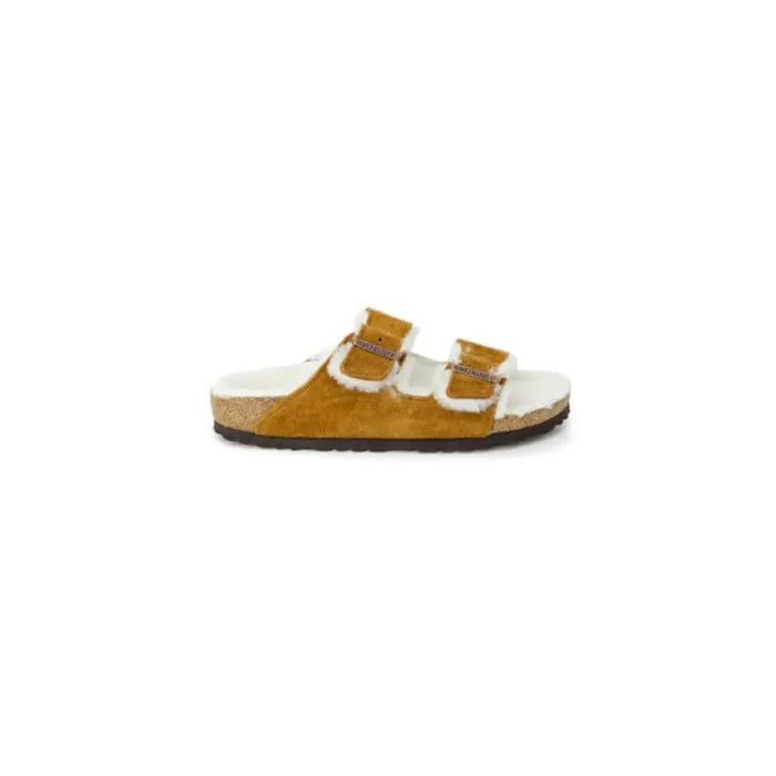 Tan suede Birkenstock women’s sandal with buckle straps and fuzzy lining, slip-on style