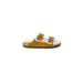 Tan suede Birkenstock women’s sandal with buckle straps and fuzzy lining, slip-on style