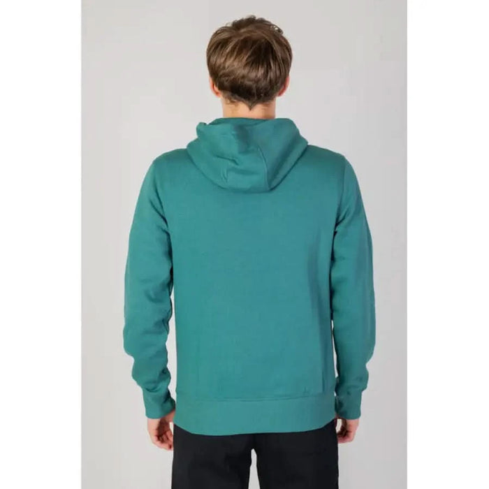 Teal hooded sweatshirt worn by a person viewed from behind New Balance Men Sweatshirts