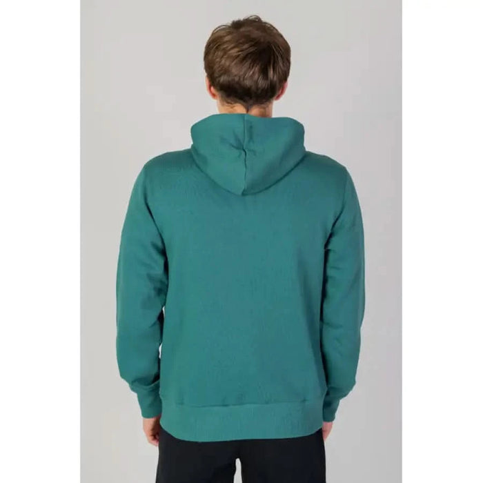 Teal hooded sweatshirt on person from back New Balance Men Sweatshirts product display