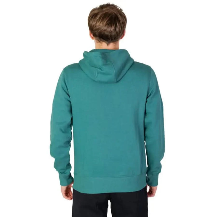 Teal hooded sweatshirt by New Balance shown from the back on a person