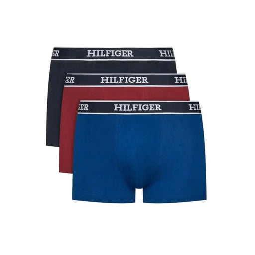 Three pairs of Tommy Hilfiger men’s boxer briefs in navy, red, and blue colors