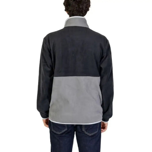 Two-tone fleece jacket with black upper and gray lower portions, displayed from behind