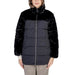 Two-tone winter puffer jacket featuring black faux fur and navy quilted design