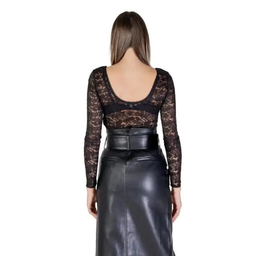 Back view of Morgan De Toi black lace top with leather skirt and wide waist belt