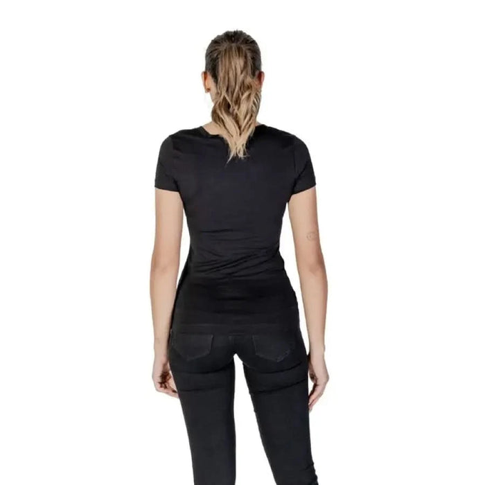 Back view of person in Guess Women’s Black T-Shirt with Rhinestones and Print