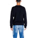 Back view of person in black sweater and blue jeans from Armani Exchange Men Sweatshirts