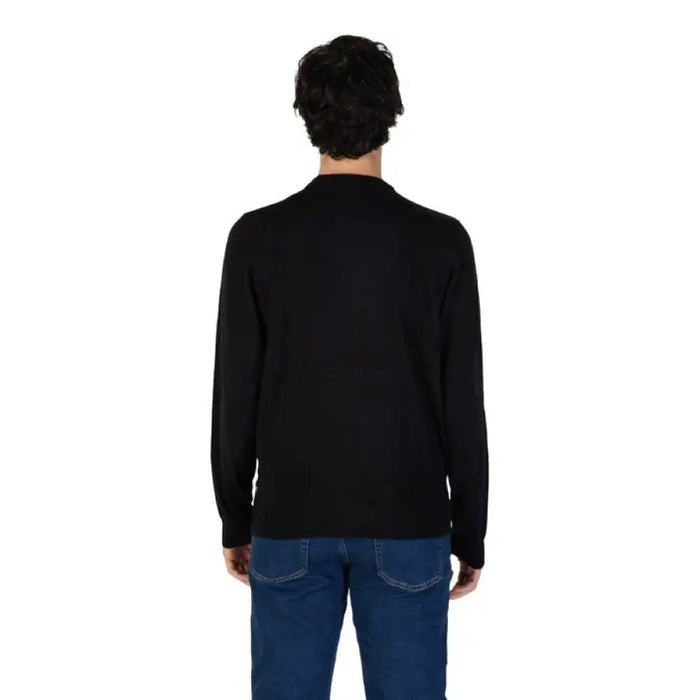 Back view of a person in Gas Men’s Black Knit Sweater and blue jeans