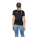 Back view of a person in Guess Women Black Round Neck Short T-Shirt and blue jeans