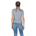 Back view of a person in gray t-shirt and blue jeans showcasing Guess Women’s Light Blue T-Shirt