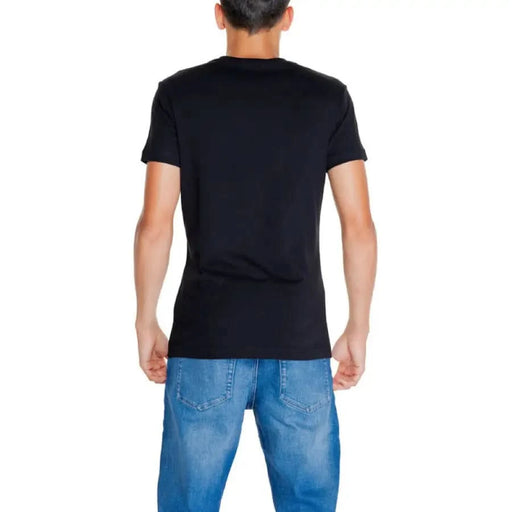 Back view of a person in Calvin Klein Jeans Men T-Shirt and blue jeans