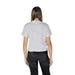 Back view of a model in a Calvin Klein Jeans white cotton t-shirt and dark jeans