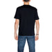 Back view of a person wearing Ea7 Men T-Shirt in plain black paired with blue jeans