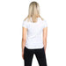 Back view of a blonde woman in an Armani Exchange white t-shirt and black pants