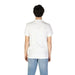 Back view of a person in white t-shirt and light blue jeans from Calvin Klein Jeans