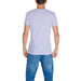 Back view of a person in a white Calvin Klein Men T-Shirt and blue jeans