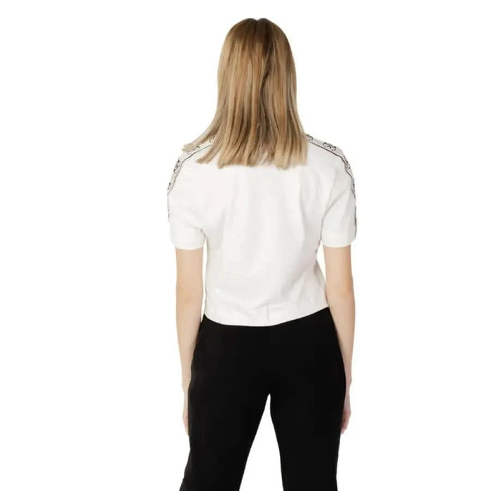 Back view of person in white shirt and black pants wearing Guess Active Women T-Shirt