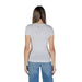 Back view of Guess Women’s White Print T-Shirt paired with blue jeans