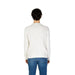 Back view of a man in a US Polo Assn white sweater and blue jeans